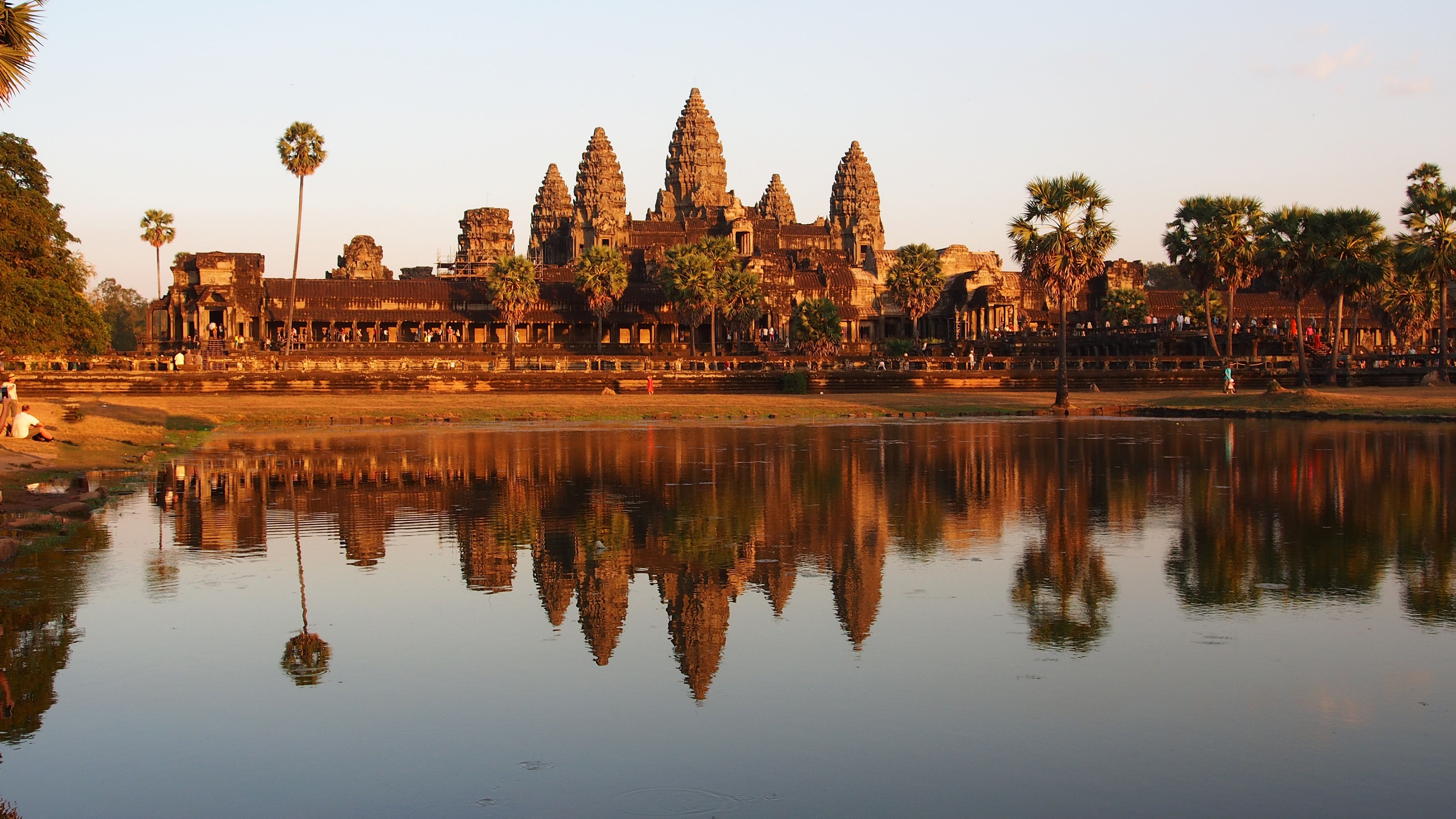 buildings surrounded by water during golden hour