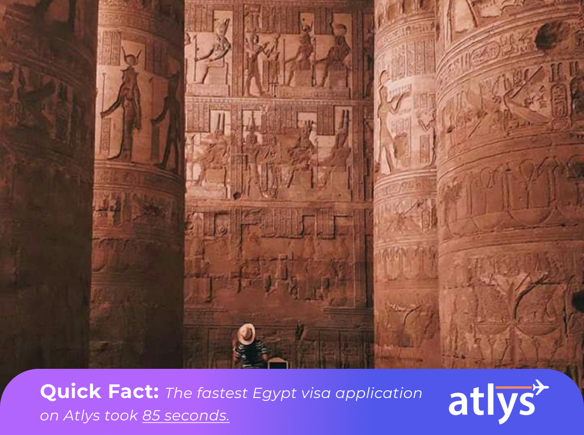 A tourist in awe of the surrounding Egypt architecture and hieroglyphics