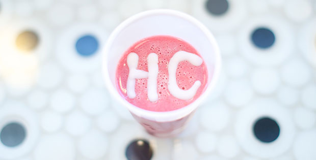 Strawberry and raspberry smoothie (Hard Candy Smoothie) with a white HC on the top. Polka dot counter top.