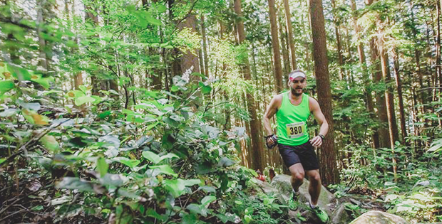 man trail running through the forest