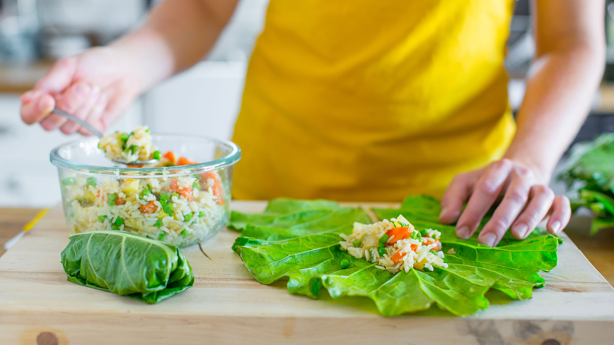 putting fried rice in collard green leaf