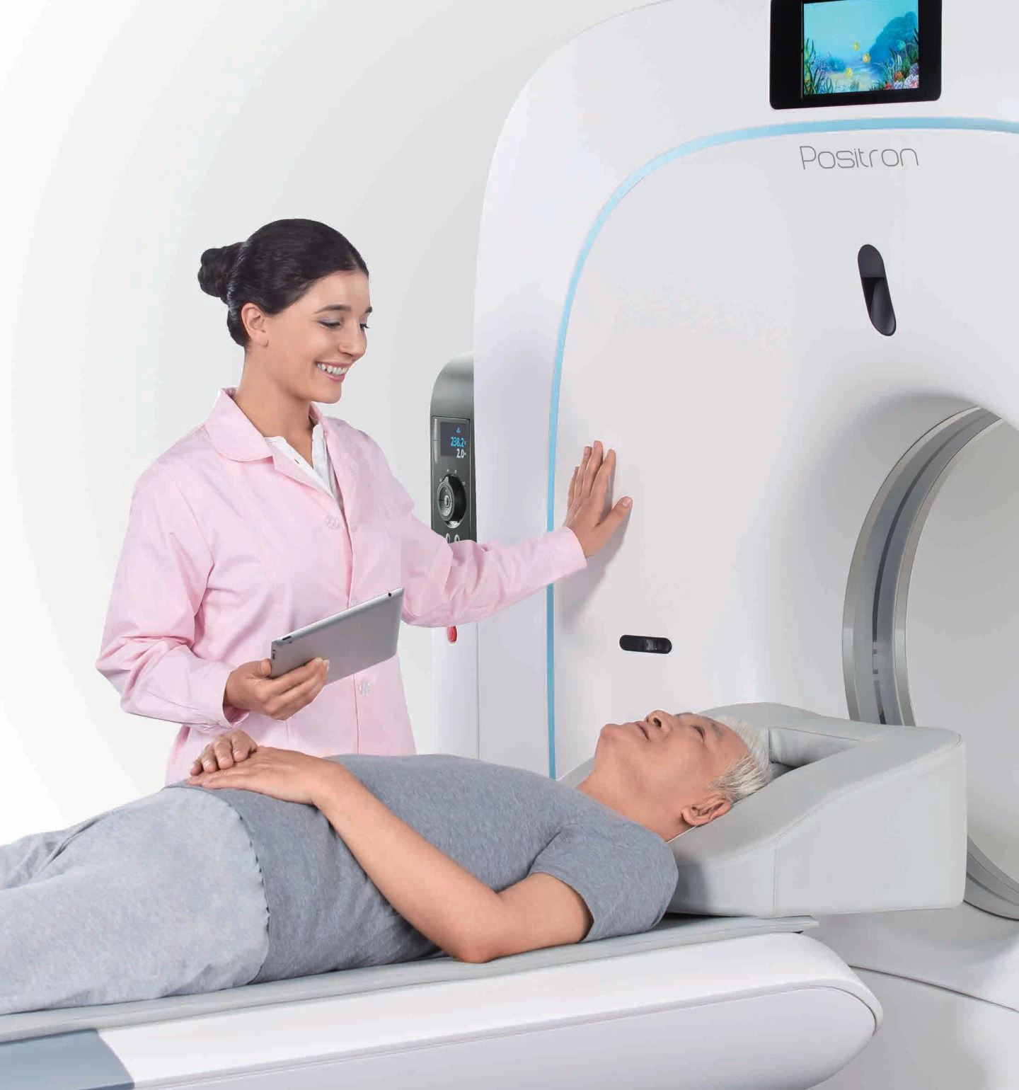 Healthcare worker administers an exam with Positron PET