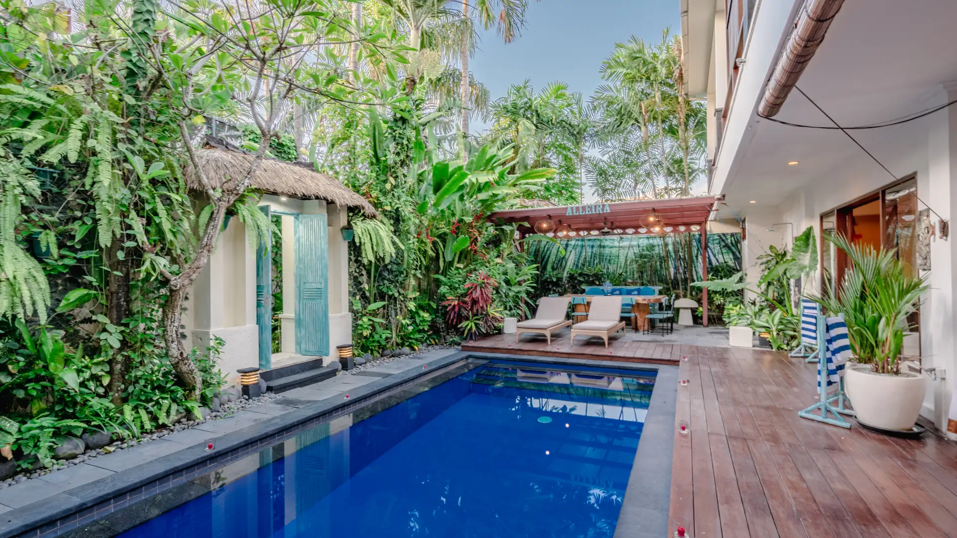 Large private pool surrounded by loungers and lush garden - Villa Alleira