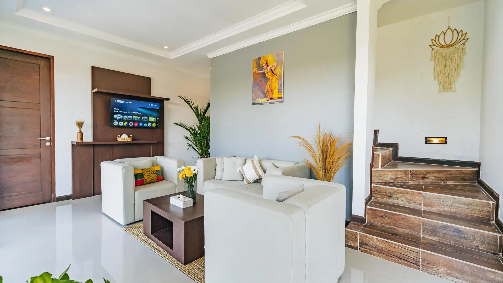Ground floor living room with cozy sofa and garden view - Villa Griya Purnama