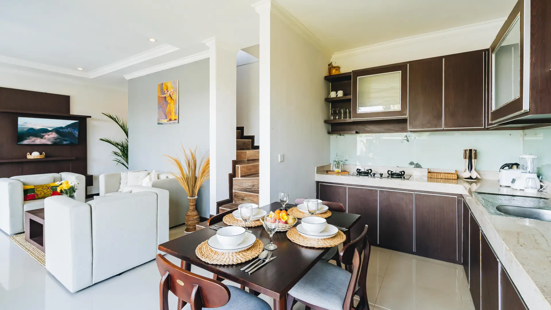 Ground floor living room with cozy sofa and garden view - Villa Griya Purnama