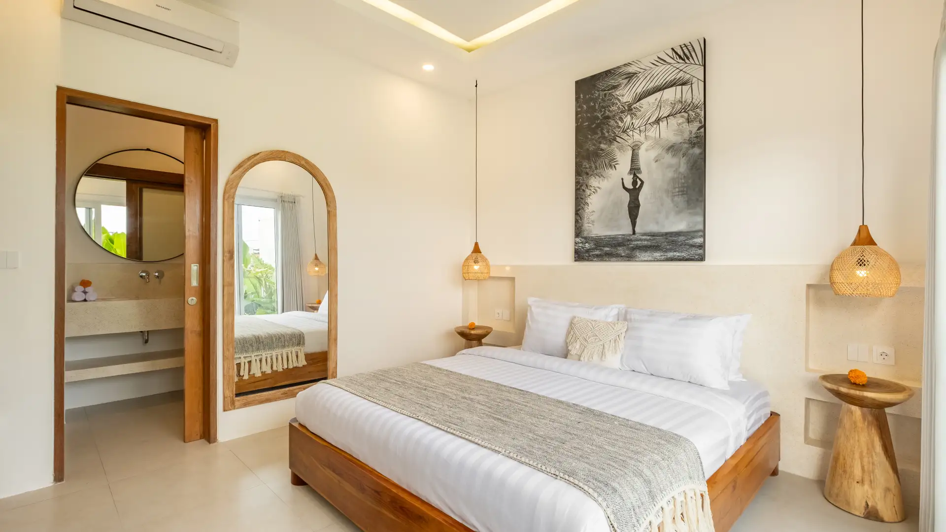 Spacious bedroom with king-size bed and garden view at Villa Merlin