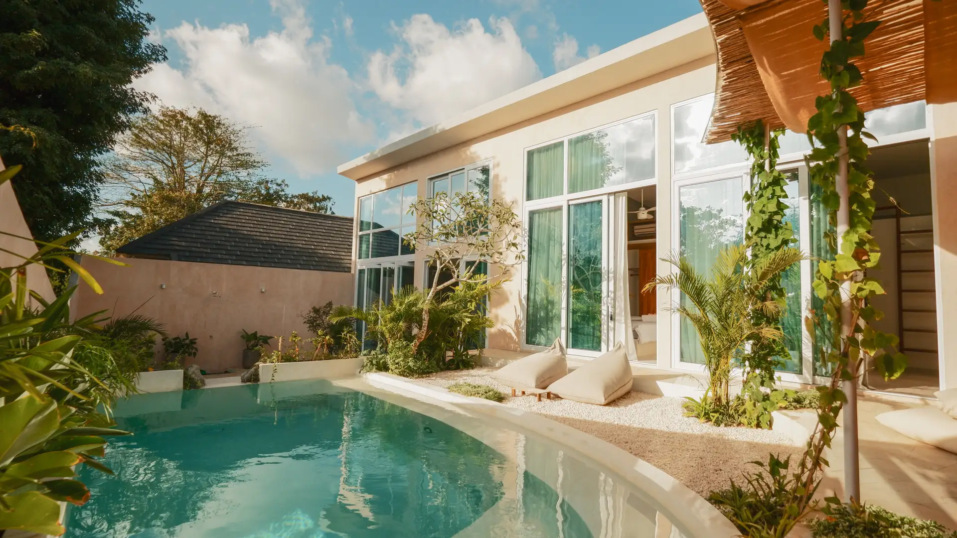 Boho-inspired tropical swimming pool with lush garden view - Villa Waha Uluwatu