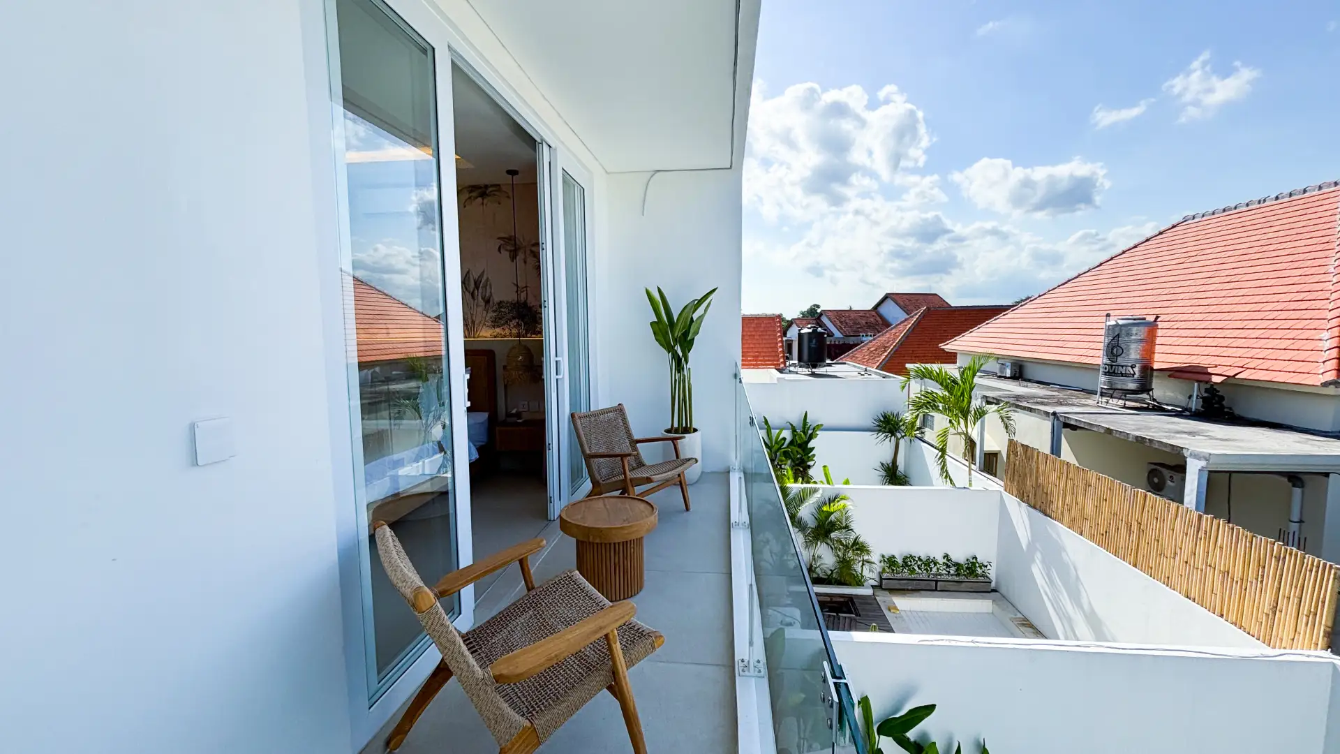 Private balcony seating area with pool view – Villa Balinay