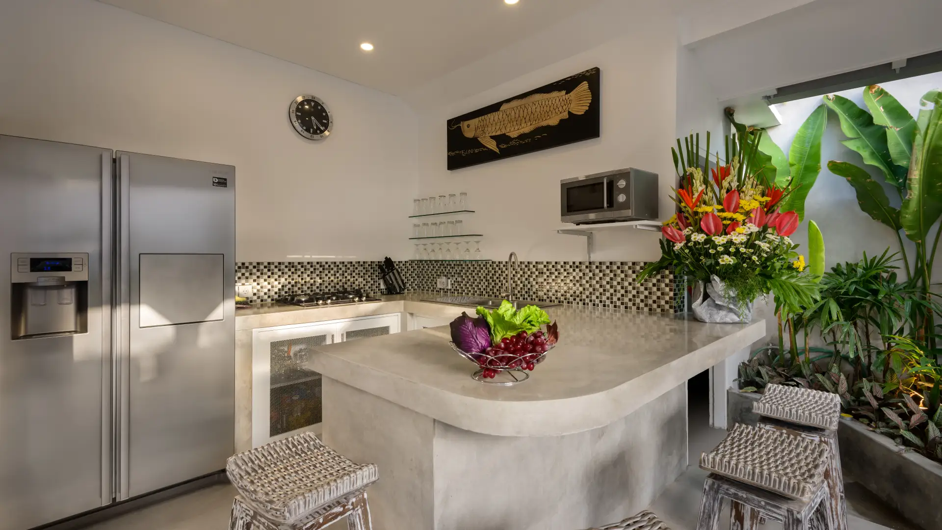 Fully equipped kitchen and glass dining table at Villa Ozamiz Seminyak