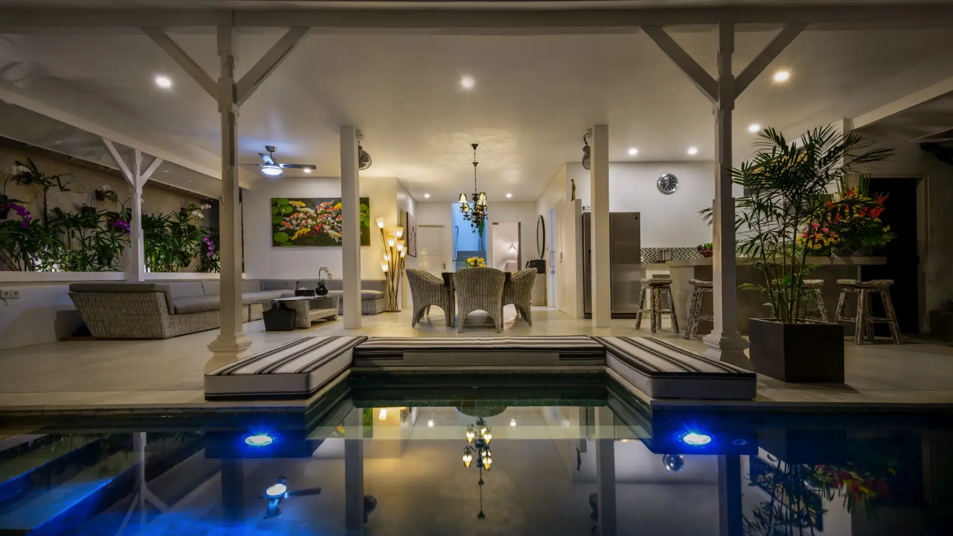 Pool area with warm lighting for evening lounging - Villa Ozamiz Seminyak