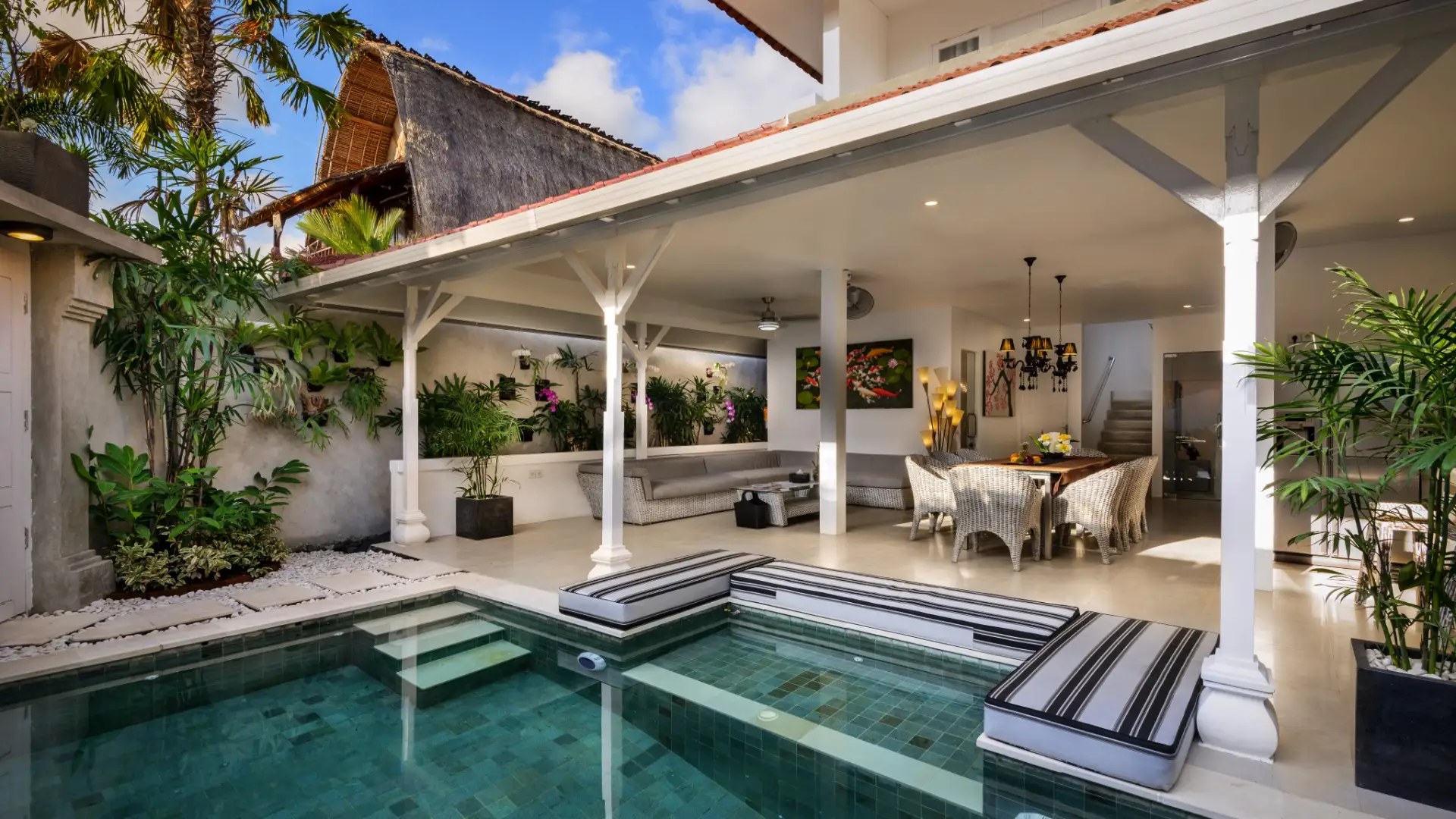 Private swimming pool with lounging area at Villa Ozamiz Seminyak