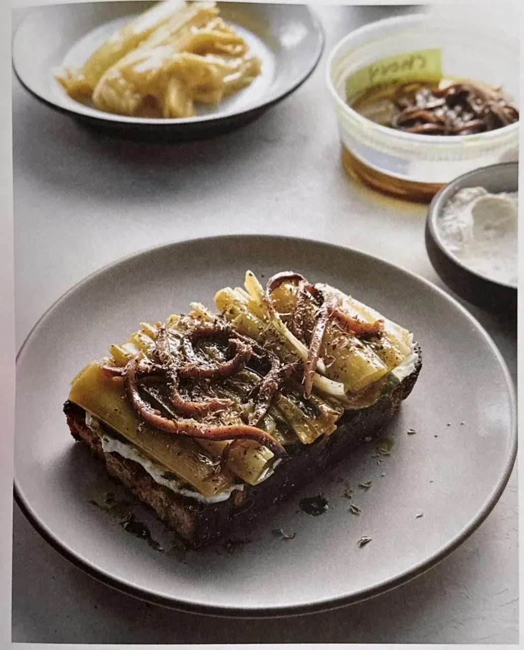 Braised Leek Toast with Whipped Ricotta, Oregano Oil, and Cantabrian Anchovies - Image 1