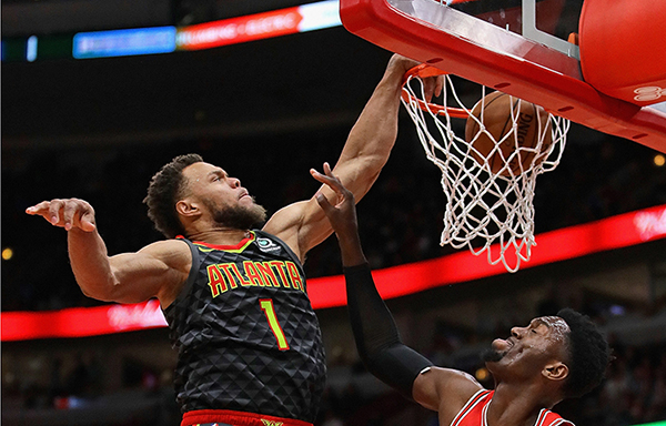 CHICAGO, ILLINOIS - JANUARY 23: Justin Anderson #1 of the Atlanta Hawks dunks over Bobby Portis #5 of the Chicago Bulls at the United Center on January 23, 2019 in Chicago, Illinois. NOTE TO USER: User expressly acknowledges and agrees that, by downloading and or using this photograph, User is consenting to the terms and conditions of the Getty Images License Agreement. (Photo by Jonathan Daniel/Getty Images)