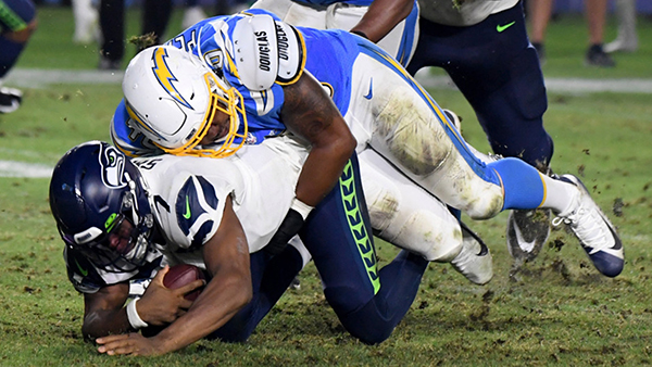 Linebacker Chris Peace #40 of the Los Angeles Chargers sacks quarterback Geno Smith #7 of the Seattle Seahawks in the second half of a pre-season NFL football game at the Dignity Health Park on Saturday, Aug. 24, 2019. (Photo by Keith Birmingham, Pasadena Star-News/SCNG)