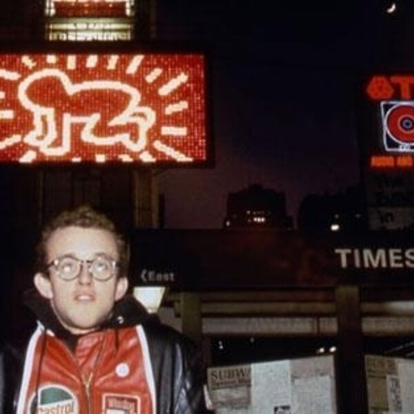 Keith Haring in front of Spectacolor Billboard, NYC