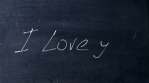 I love you. Handwritten chalk on a black chalkboard. Arrow shot heart shape. Love at school concept.