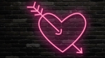 Red pink heart amazed by arrow. Neon glow flashings. Turn on and turn off. Dark brick background. Pink light electric fluorescent.