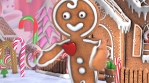 Cute Gingerbread man dancing salsa in a candy village. Seamless funny Christmas animation with ginge