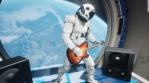 An astronaut on his spaceship plays space music on an electric guitar.