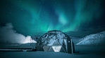 Geothermal electrical power generator metal dome night sky stars flashing aurora Iceland winter 4k