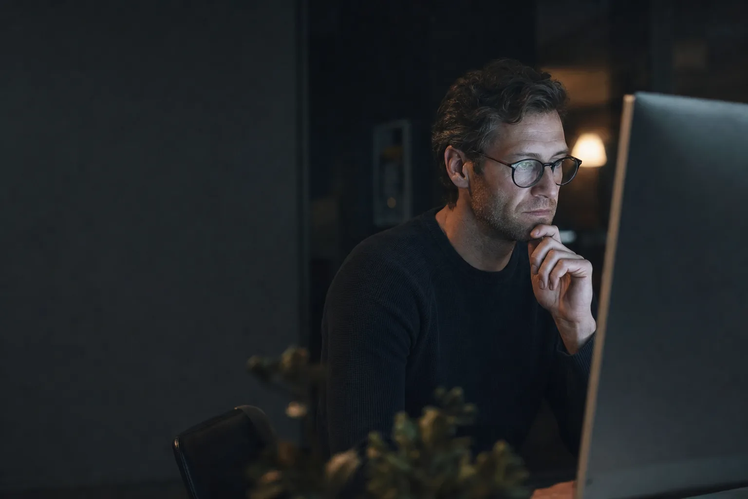 Editorial photograph: an operator reviewing machine output on screen, accompanying Internal Search with RAG.