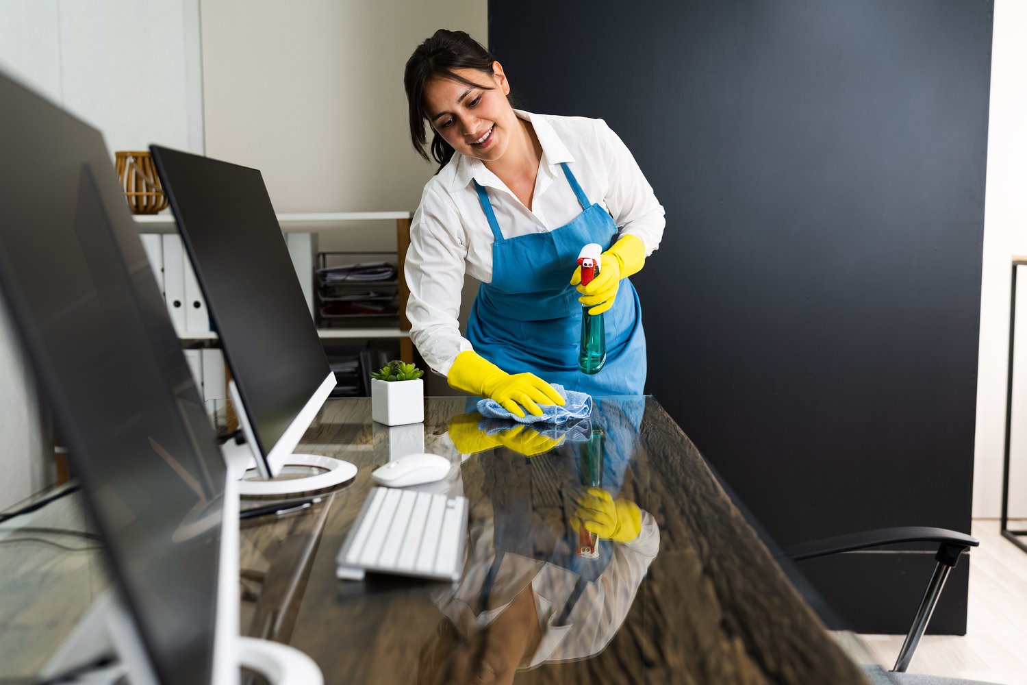 bigstock-Janitor-Cleaning-Office-Desk--385829566.jpeg