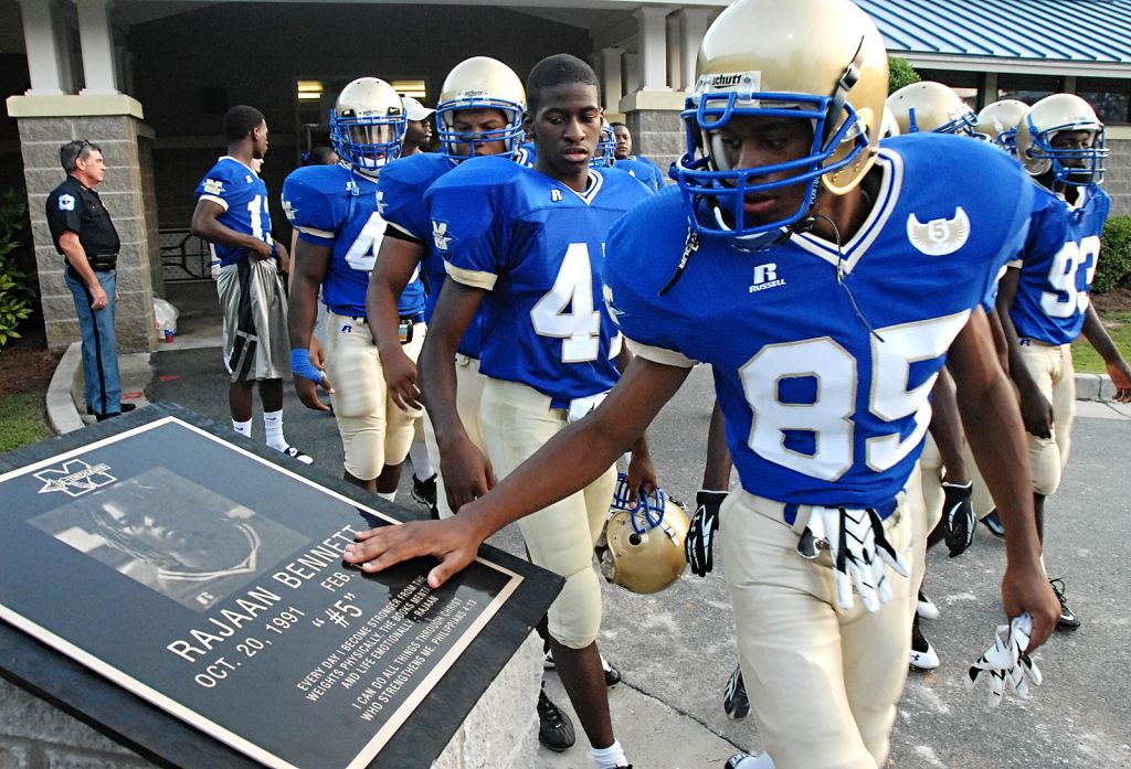 A bronze plaque dedicated to Rajaan rests on a carved stone podium at McEachern's Cantrell Stadium.