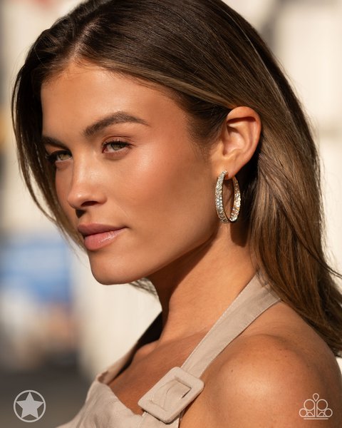 woman with brown hair wearing paparazzi accessories glitzy by association hoop earrings in gold