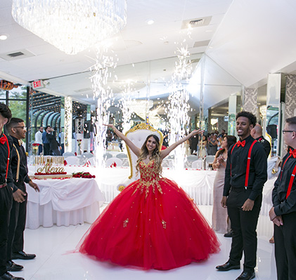 Quinceañera celebration with sparklers in ballroom