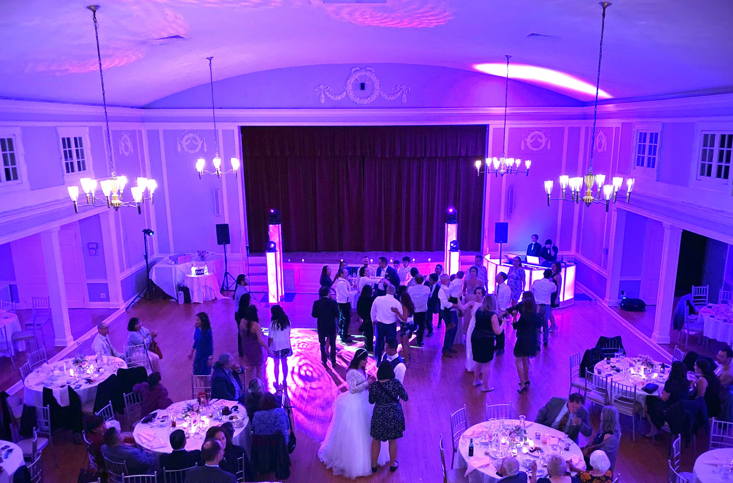 Grand hall full of wedding guests dancing