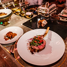 Plated gourmet meat course with fresh greens prepared by the estate kitchen