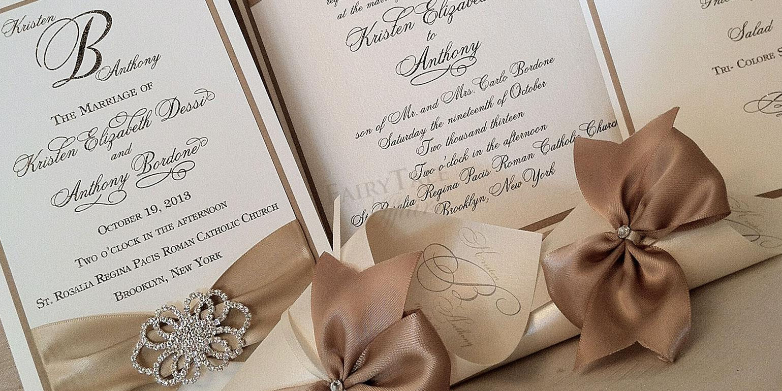 Elegant wedding invitation stationery with script lettering, satin ribbon and a rhinestone brooch