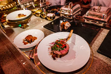 Plated gourmet dishes prepared on a catering station at an event