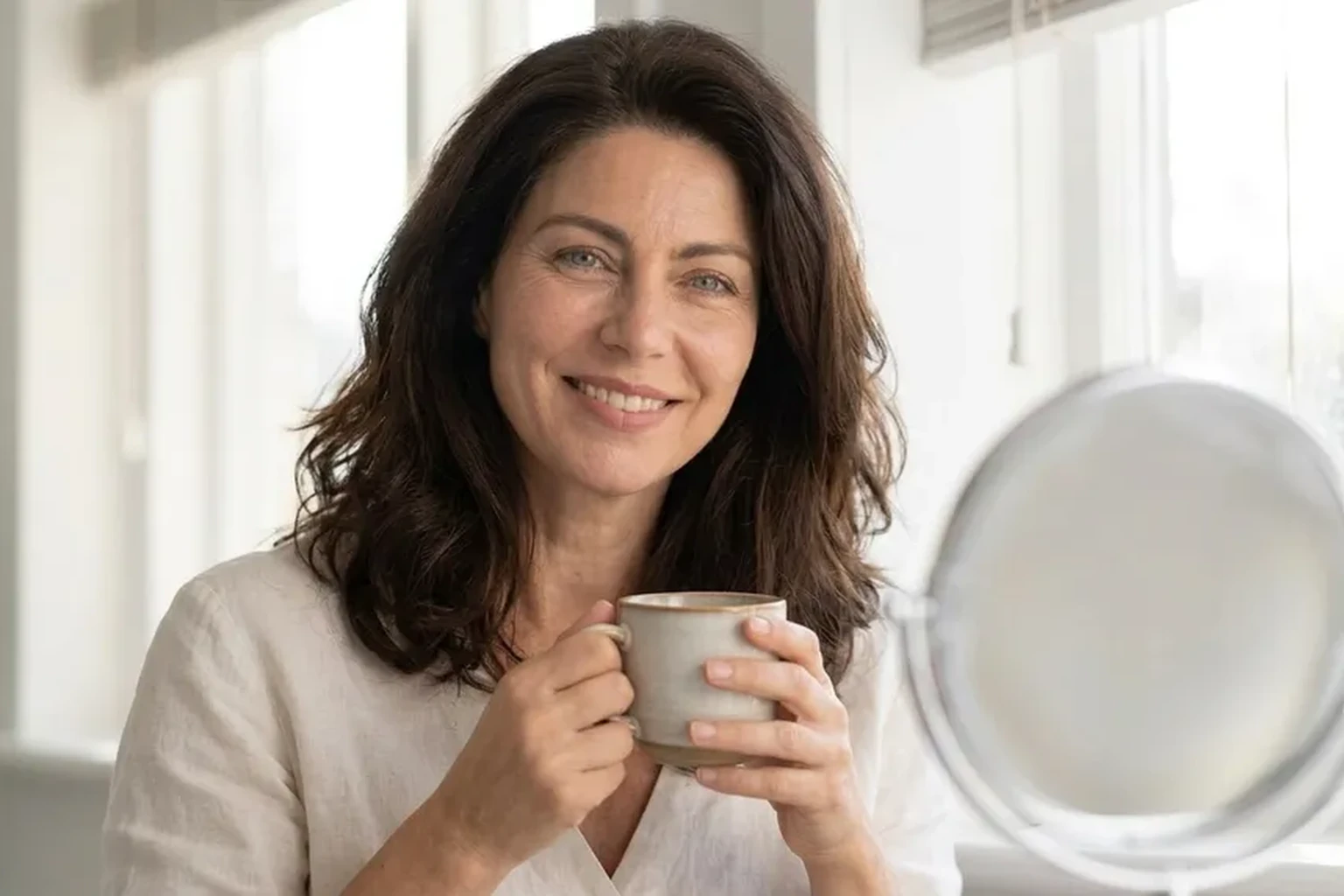 Woman waking up calm with a flat, comfortable stomach after weeks on Tributyrin-X