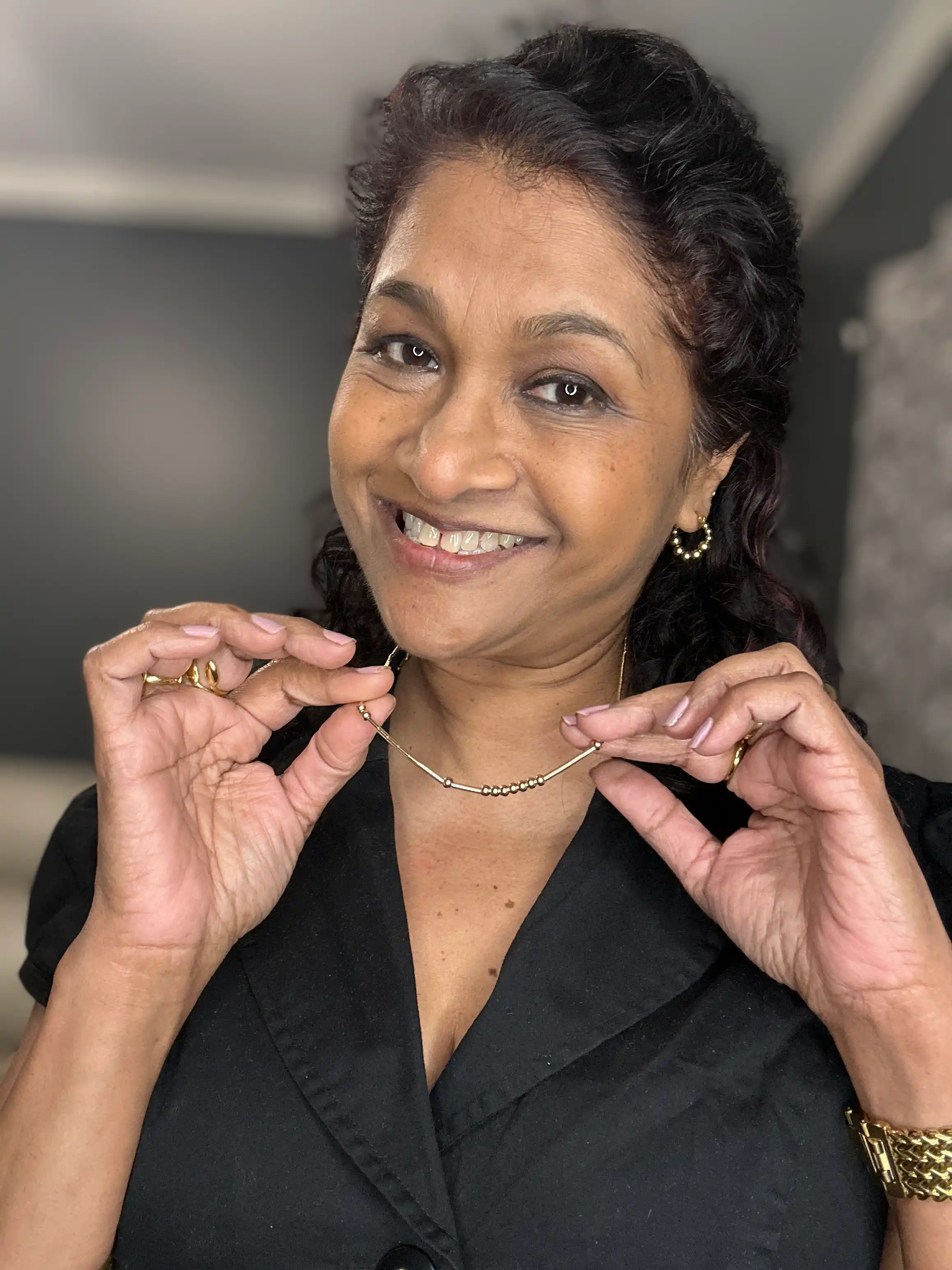 Customer holding up her Tulas Morse code necklace