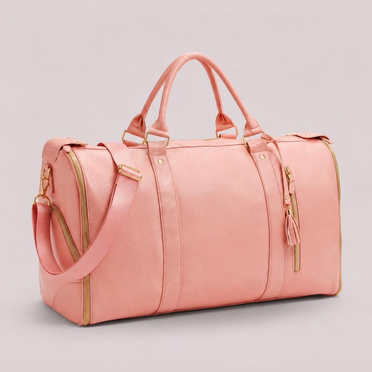 The rose pink Luhxe Travel Bag 2.0 standing upright, soft leather with gold zippers and detachable strap