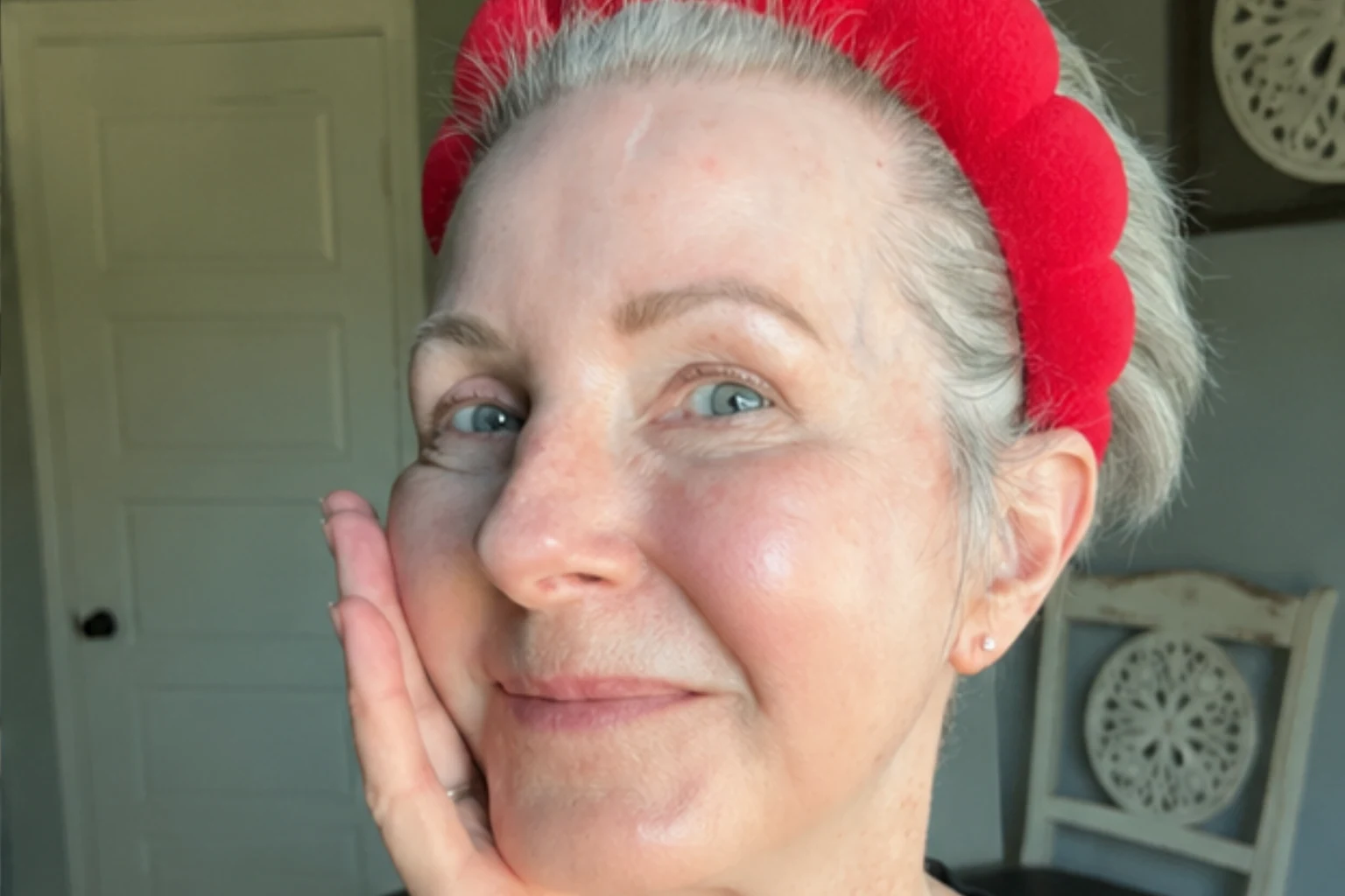 The same woman bare-faced in the morning, skin looking firmer and more rested