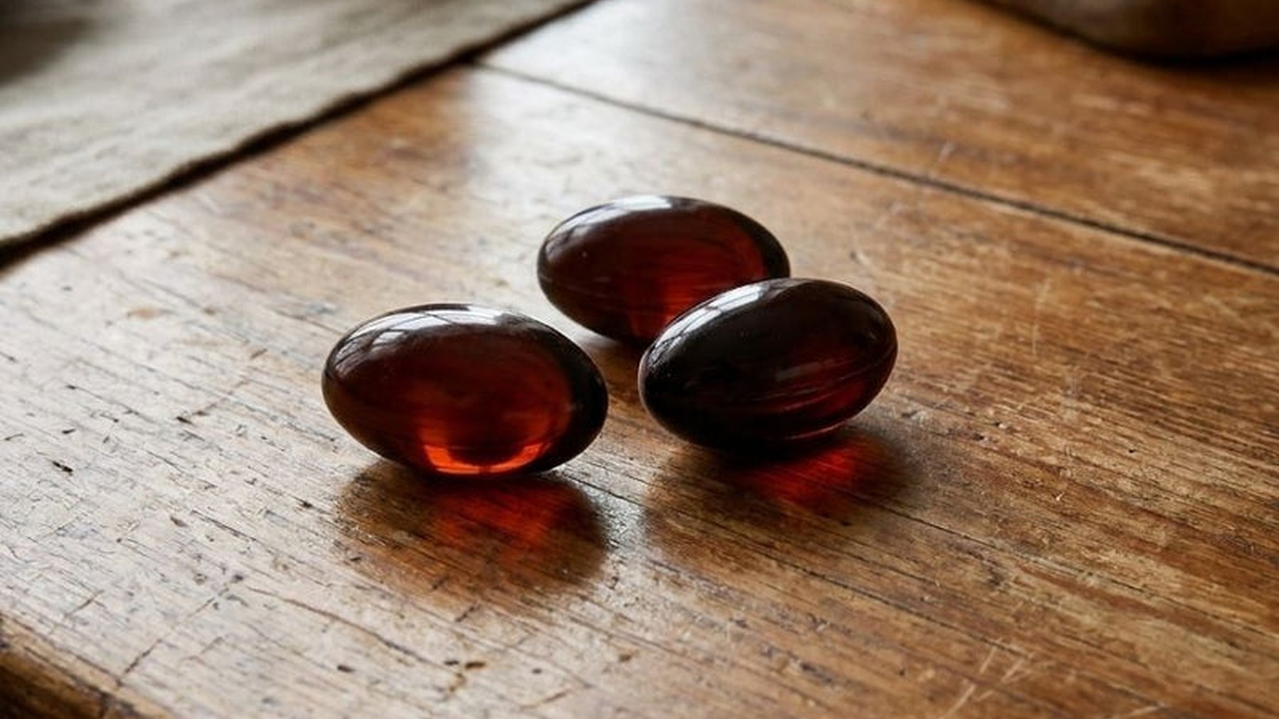 EverWell Black softgels on a wooden table