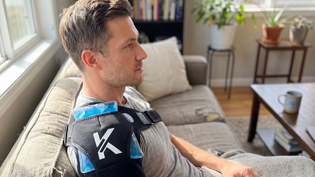 Man resting on the couch with a cold pack in the brace pocket