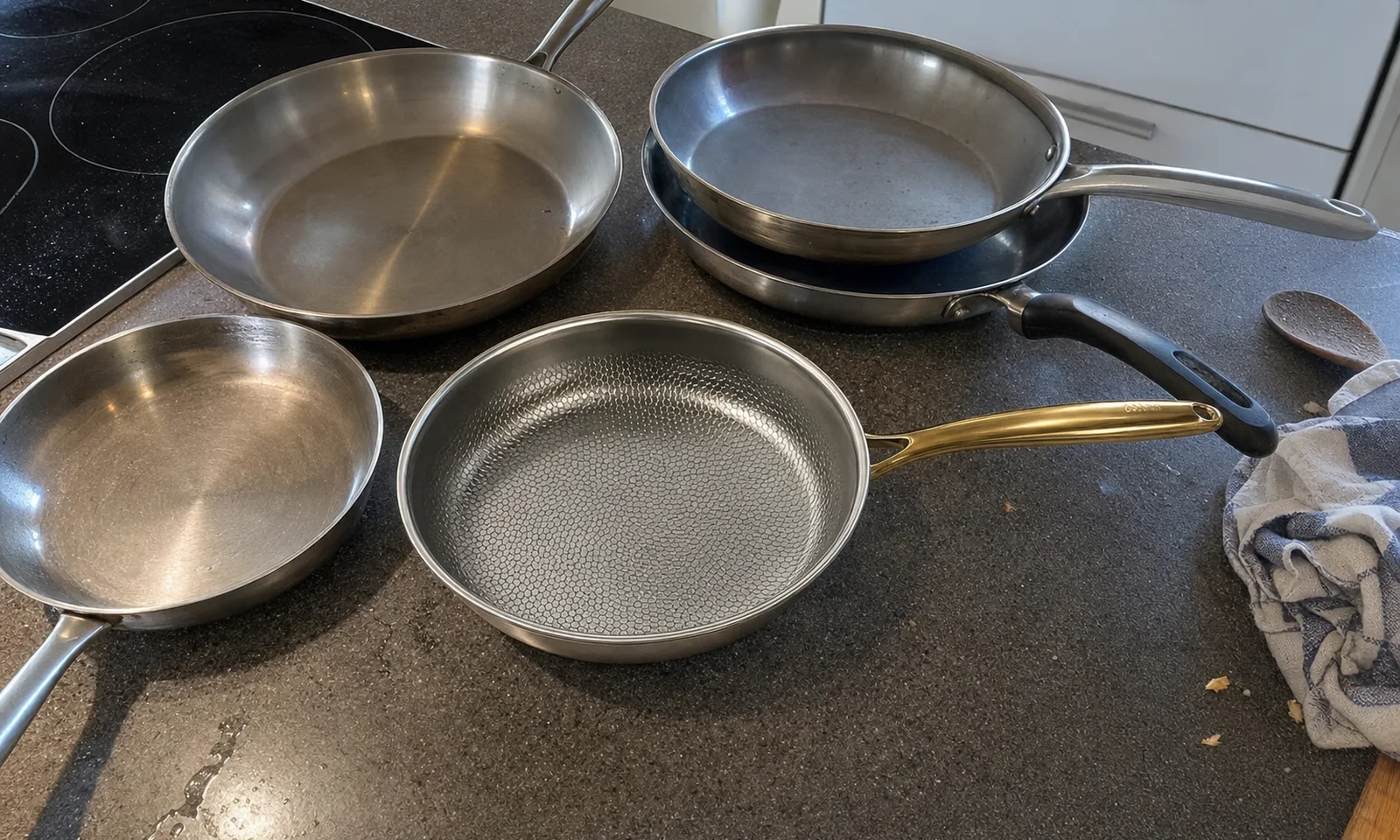 The five titanium frying pans we tested, set out on a kitchen counter