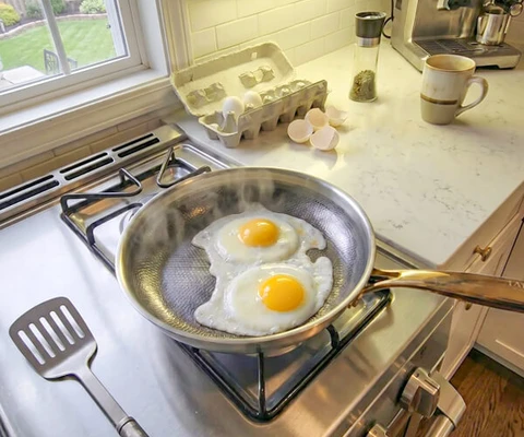 Eggs cooking in a titanium pan