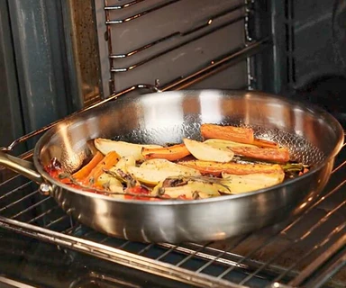 A titanium pan going into a hot oven