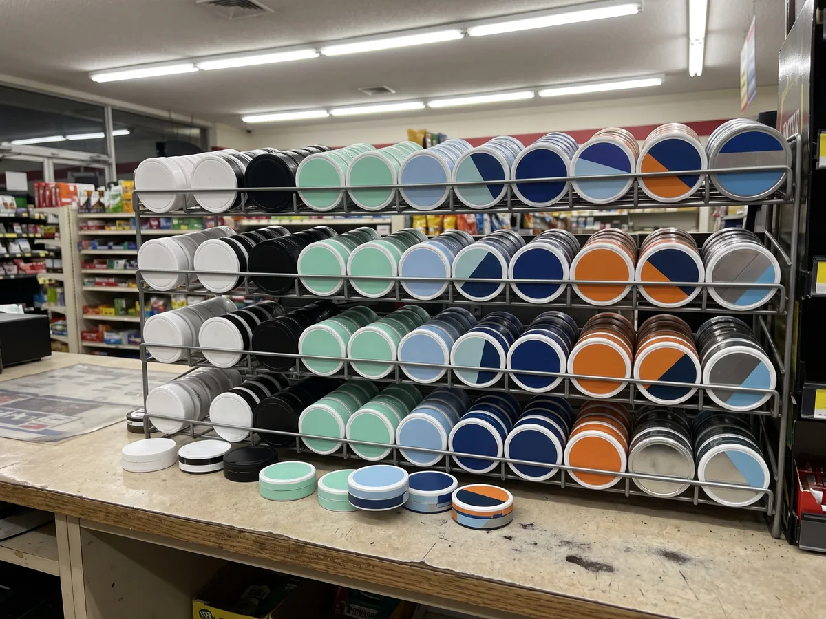 A convenience store counter display packed with rows of look-alike pouch cans