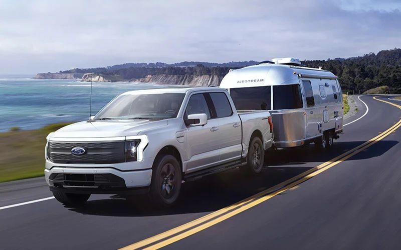 image of silver ford truck towing airstream camper