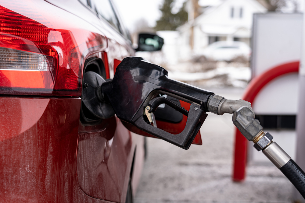 red car refueling with gas