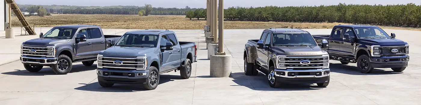 image of four dark colored ford trucks