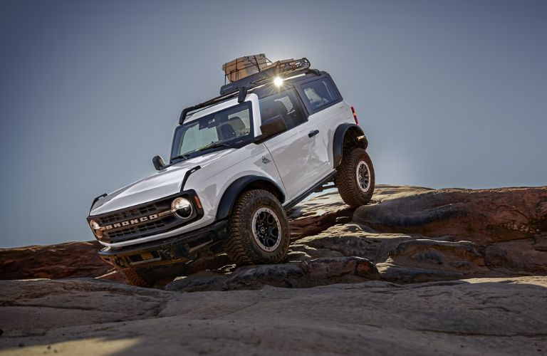 White 2024 Ford Bronco 2-Door Coming Down a Rock Formation