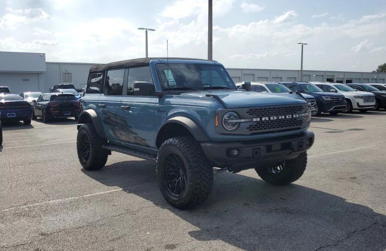 Blue 2024 Ford Bronco with Lift Kit and Custom Wheels on the Brandon Ford Lot