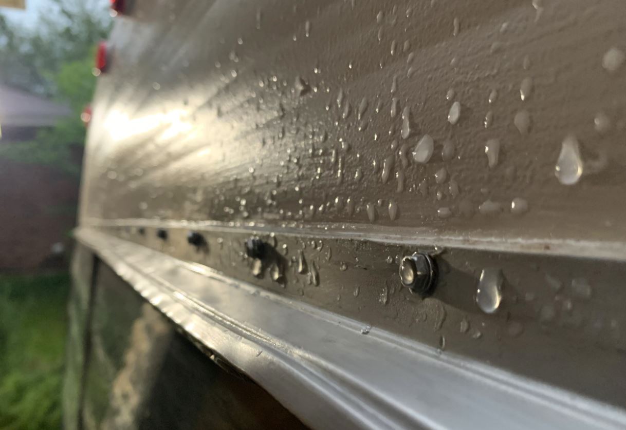 closeup of RV sidewall wet from raindrops