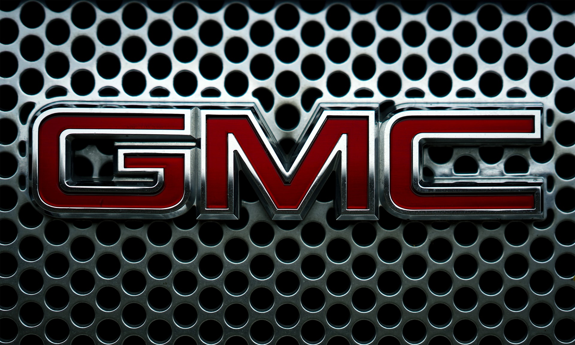 red General Motor Company (GMC) logo on a grille